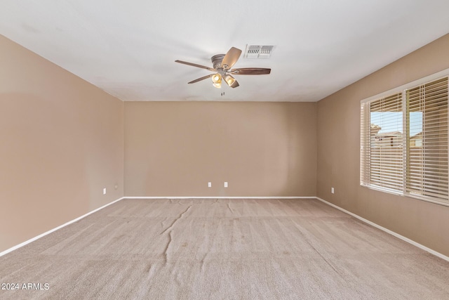 carpeted empty room featuring ceiling fan