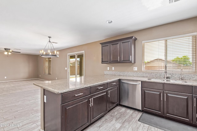 kitchen with stainless steel dishwasher, kitchen peninsula, sink, and light hardwood / wood-style flooring