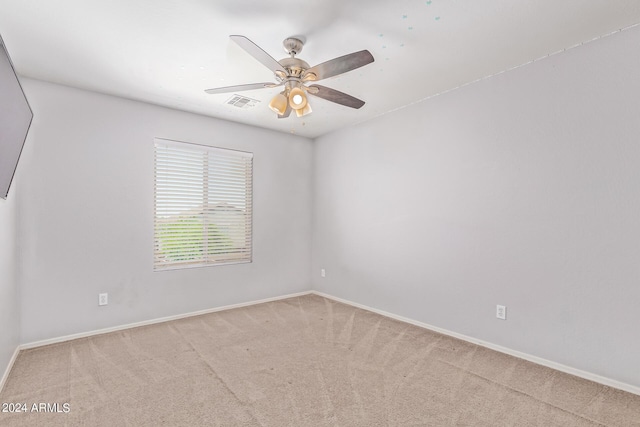 carpeted spare room with ceiling fan