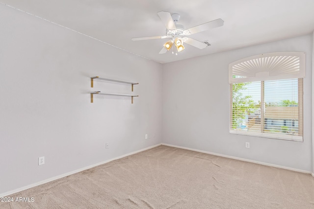 spare room featuring carpet flooring and ceiling fan