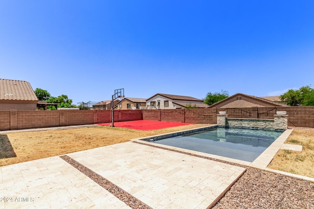 view of pool with a patio area and basketball court