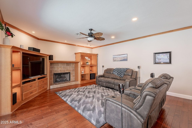 20809 N 17th St, Phoenix, AZ 85024 - living room with dark wood-style floors, ceiling fan, crown molding, a stone fireplace, and recessed lighting