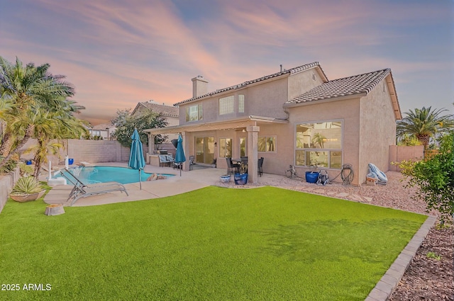 20809 N 17th St, Phoenix, AZ 85024 - back of property featuring a fenced backyard, stucco siding, a chimney, and a tile roof