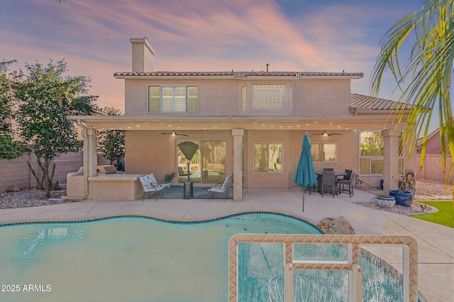 20809 N 17th St, Phoenix, AZ 85024 - back of house with a ceiling fan, a chimney, a fenced backyard, and stucco siding