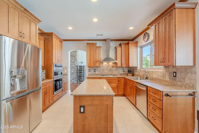 20809 N 17th St, Phoenix, AZ 85024 - kitchen featuring stainless steel appliances, wall chimney range hood, a center island, ornamental molding, and arched walkways