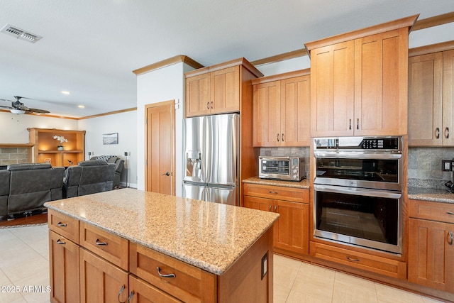 20809 N 17th St, Phoenix, AZ 85024 - kitchen with stainless steel appliances, ceiling fan, tasteful backsplash, light stone countertops, and a kitchen island