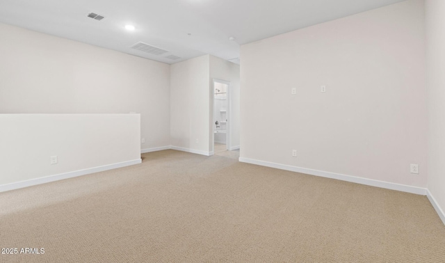 spare room featuring recessed lighting, visible vents, light carpet, and baseboards