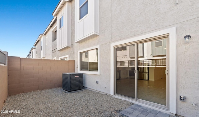 view of patio / terrace with central air condition unit and fence