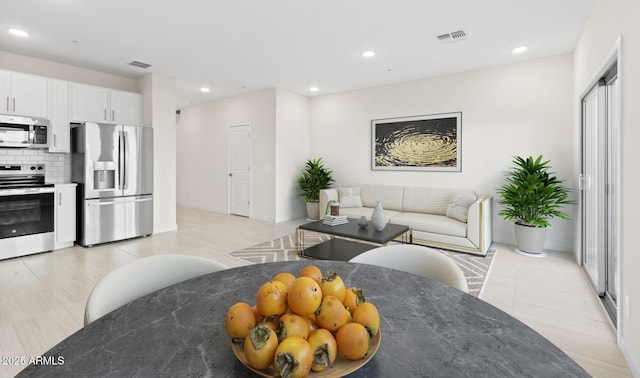 kitchen featuring tasteful backsplash, visible vents, recessed lighting, and appliances with stainless steel finishes