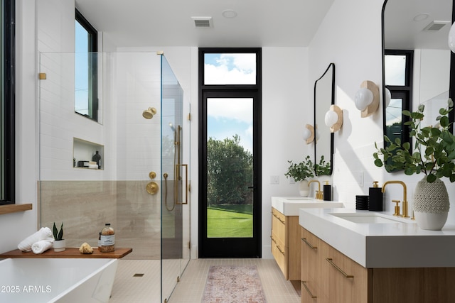 4120 N 44th Pl, Phoenix, AZ 85018 - bathroom featuring a shower stall, a freestanding tub, two vanities, and tile patterned floors