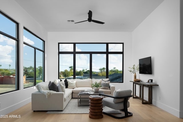 4120 N 44th Pl, Phoenix, AZ 85018 - living area featuring ceiling fan, light wood finished floors, and baseboards