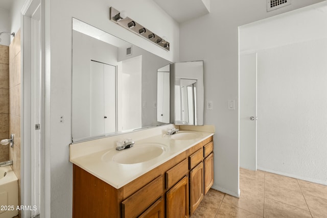 bathroom featuring washtub / shower combination, tile patterned floors, and vanity