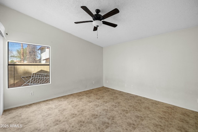 unfurnished room featuring ceiling fan, lofted ceiling, and a textured ceiling