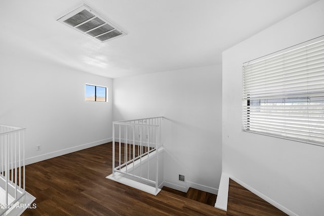 stairs featuring hardwood / wood-style flooring