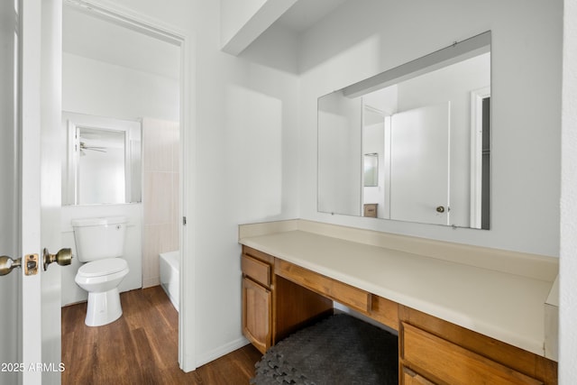 bathroom with vanity, a bathtub, wood-type flooring, and toilet