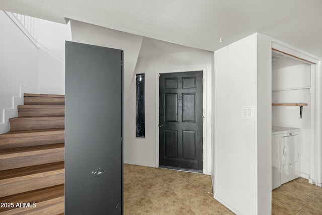 tiled foyer entrance with a textured ceiling