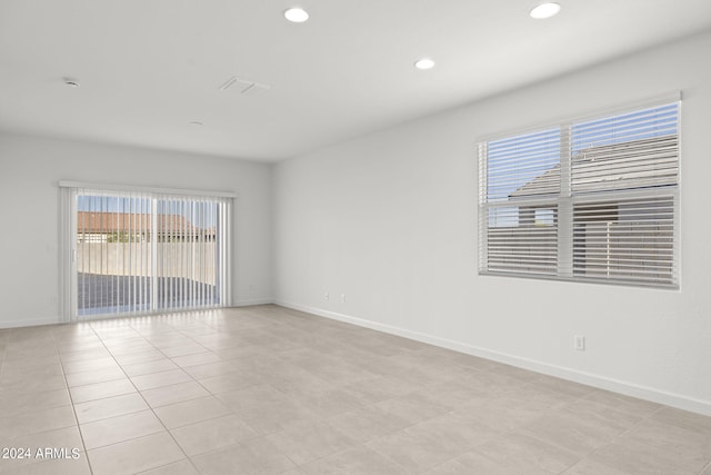 unfurnished room featuring light tile patterned floors