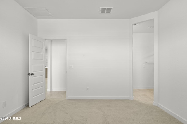 spare room with light colored carpet