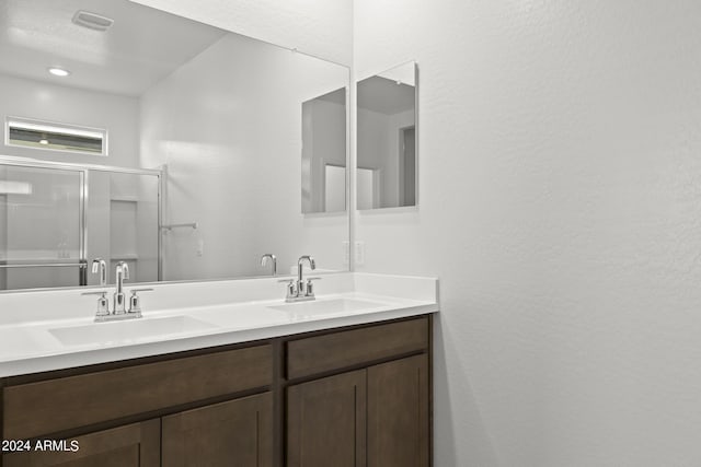 bathroom with vanity and an enclosed shower