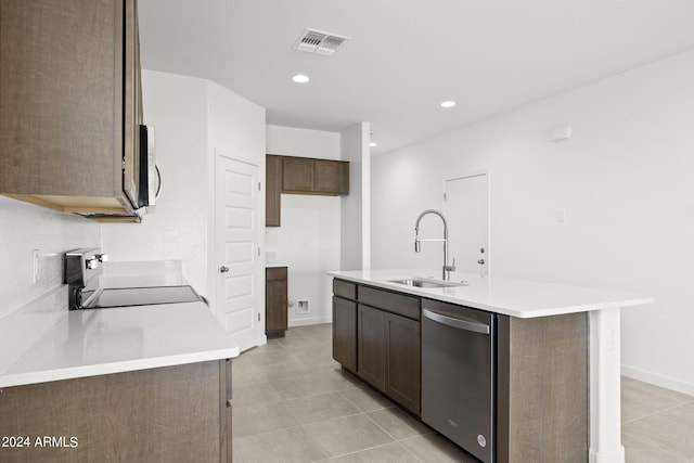 kitchen featuring stove, stainless steel dishwasher, sink, a center island with sink, and light tile patterned flooring