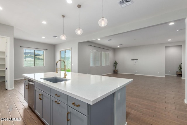 5139 N 185th Ave, Litchfield Park, AZ 85340 - kitchen featuring gray cabinets, light wood-style floors, open floor plan, dishwasher, and recessed lighting
