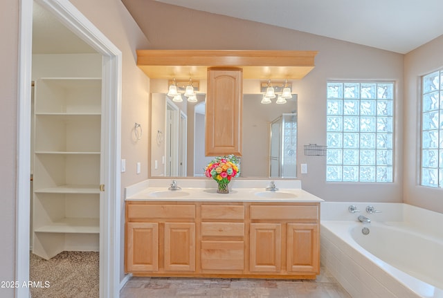 20277 N 68th Dr, Glendale, AZ 85308 - full bath with a chandelier, double vanity, a bath, lofted ceiling, and a closet