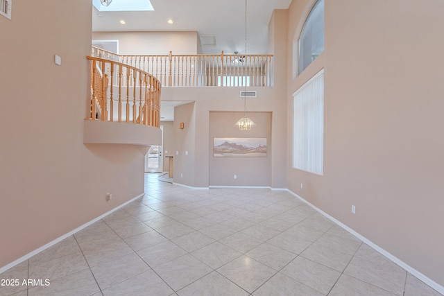 20277 N 68th Dr, Glendale, AZ 85308 - unfurnished living room featuring tile patterned flooring, a skylight, a towering ceiling, and recessed lighting