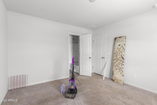 unfurnished bedroom with light colored carpet