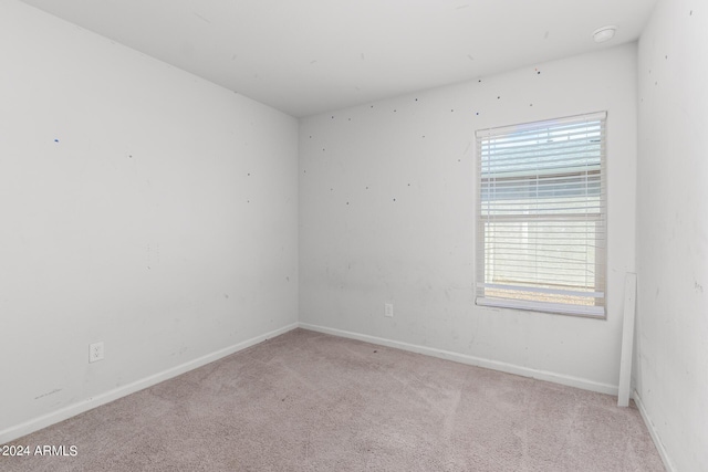 carpeted spare room with a healthy amount of sunlight