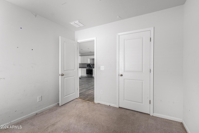 unfurnished room with light colored carpet