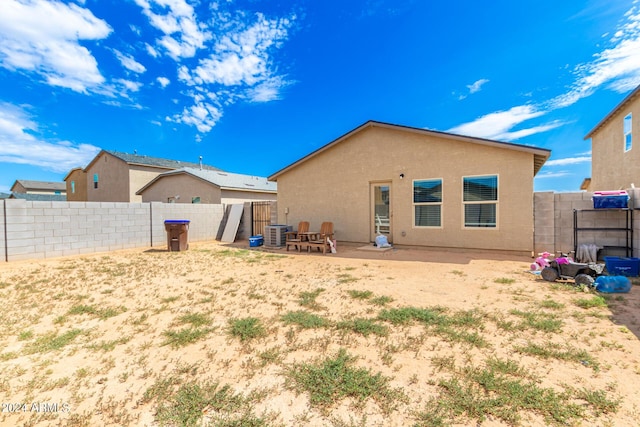 back of property with cooling unit and a patio area