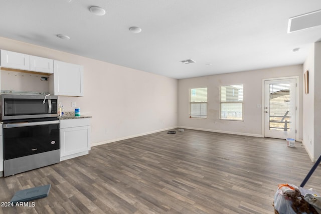 kitchen with white cabinetry, oven, and dark hardwood / wood-style flooring