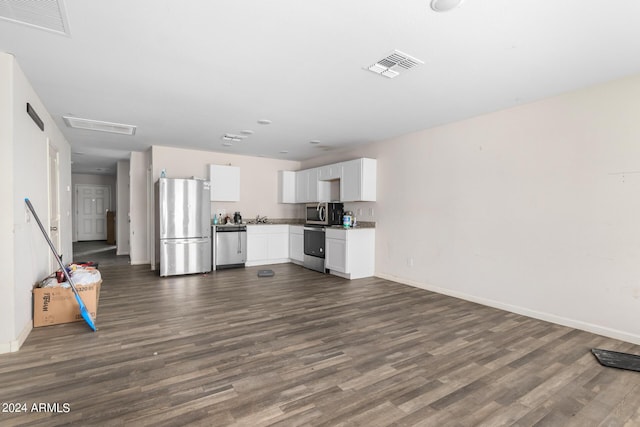 kitchen featuring dark hardwood / wood-style flooring, sink, white cabinets, and appliances with stainless steel finishes