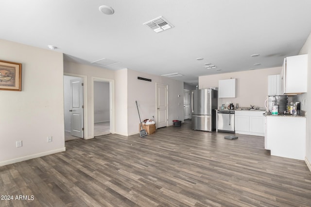 unfurnished living room featuring sink and dark hardwood / wood-style floors