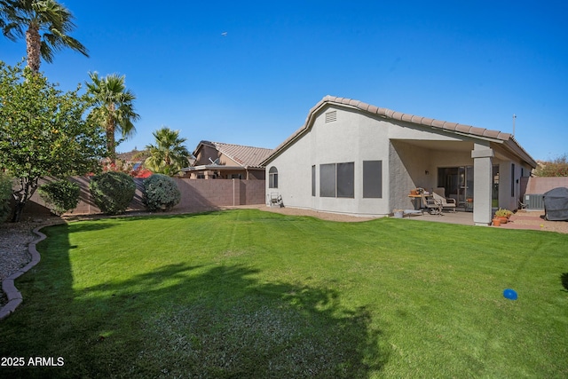 back of property with a patio and a lawn