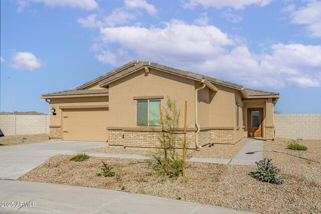 680 W Crowned Dove Trl, Casa Grande, AZ 85122 - view of side of home with driveway, stucco siding, and brick siding