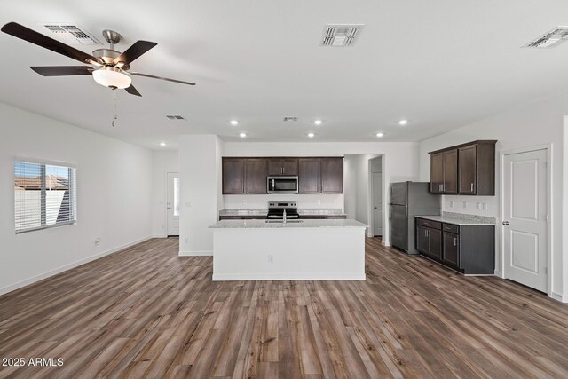 680 W Crowned Dove Trl, Casa Grande, AZ 85122 - kitchen with dark wood-style floors, visible vents, appliances with stainless steel finishes, and open floor plan