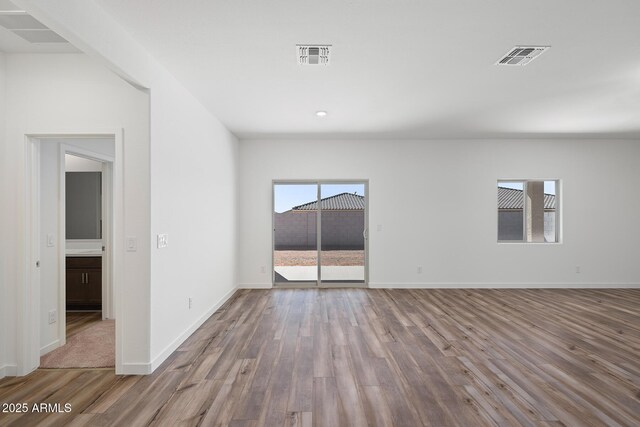 680 W Crowned Dove Trl, Casa Grande, AZ 85122 - empty room featuring visible vents, wood finished floors, and baseboards