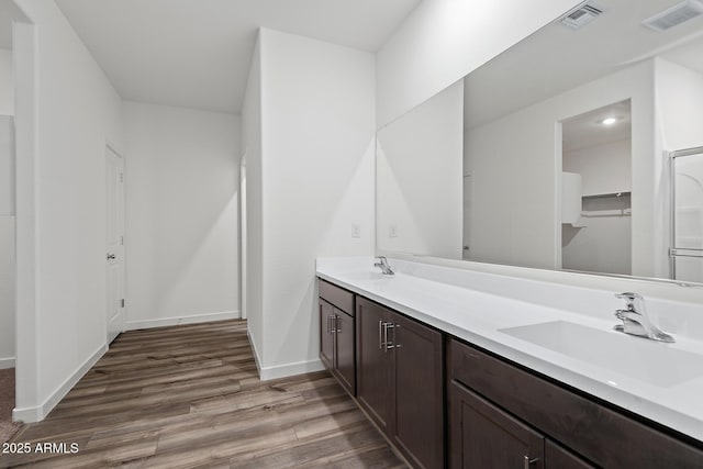 680 W Crowned Dove Trl, Casa Grande, AZ 85122 - bathroom featuring baseboards, visible vents, wood finished floors, and a sink