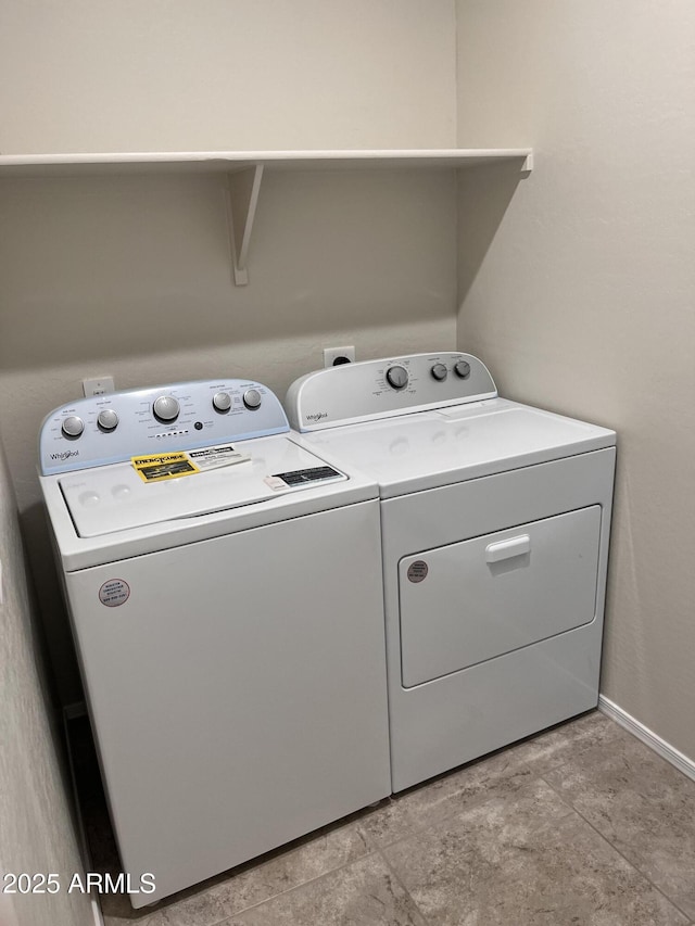 clothes washing area with washer and dryer