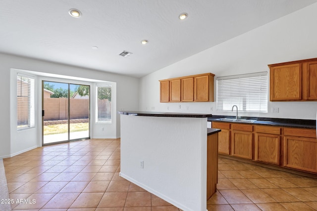 1669 E Santa Fiore St, San Tan Valley, AZ 85140 - kitchen featuring a sink, vaulted ceiling, light tile patterned floors, dark countertops, and recessed lighting