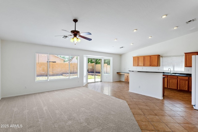 1669 E Santa Fiore St, San Tan Valley, AZ 85140 - kitchen featuring open floor plan, a ceiling fan, a sink, light tile patterned flooring, and freestanding refrigerator