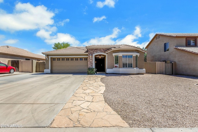 1669 E Santa Fiore St, San Tan Valley, AZ 85140 - mediterranean / spanish-style home featuring an attached garage, concrete driveway, stucco siding, and a tiled roof