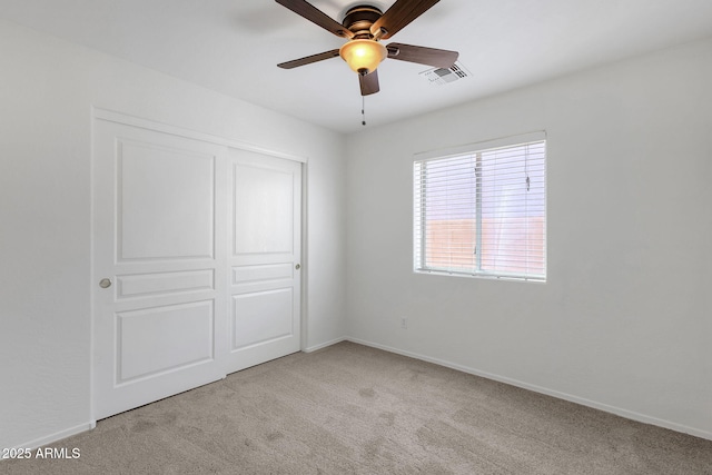 1669 E Santa Fiore St, San Tan Valley, AZ 85140 - unfurnished bedroom featuring carpet, baseboards, a closet, and a ceiling fan
