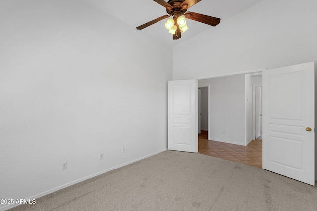 1669 E Santa Fiore St, San Tan Valley, AZ 85140 - unfurnished bedroom with carpet floors, high vaulted ceiling, baseboards, tile patterned floors, and ceiling fan
