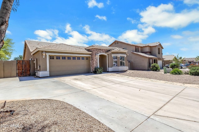 1669 E Santa Fiore St, San Tan Valley, AZ 85140 - mediterranean / spanish-style house with stucco siding, a garage, a tile roof, driveway, and fence