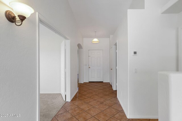 1669 E Santa Fiore St, San Tan Valley, AZ 85140 - hallway with arched walkways, baseboards, and light tile patterned flooring