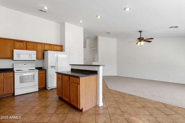 1669 E Santa Fiore St, San Tan Valley, AZ 85140 - kitchen with white appliances, light carpet, dark countertops, open floor plan, and high vaulted ceiling