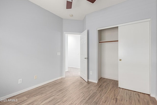 unfurnished bedroom featuring light hardwood / wood-style floors, a closet, and ceiling fan