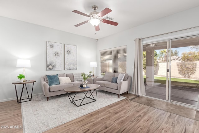 living room with ceiling fan and light hardwood / wood-style floors